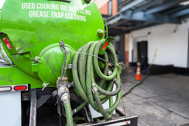 a grease trap being pumped by a sanitation technician in San Clemente CA